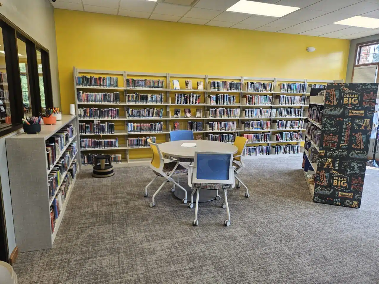 Study table and bookshelves inside the library Teen Space